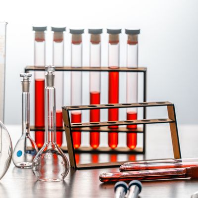Close-up of various lab glassware with red liquids, ideal for scientific or educational use.